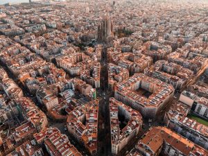aerial view of barcelona city skyline and sagrada familia cathedral at sunset.